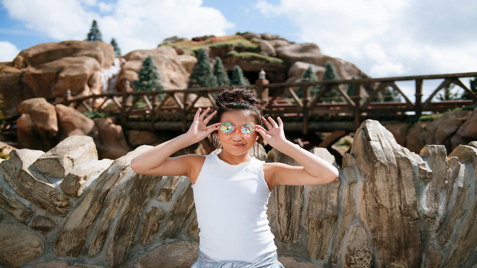 a woman taking a picture at Seven Dwarfs Mine Train, Disney World